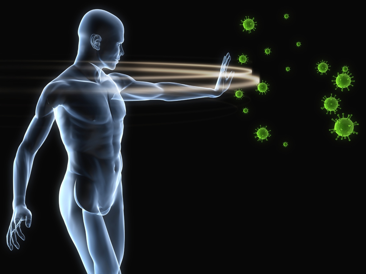 A translucent human figure extends a hand to ward off green virus-like particles on a black background, symbolizing the immune system fighting off infections.