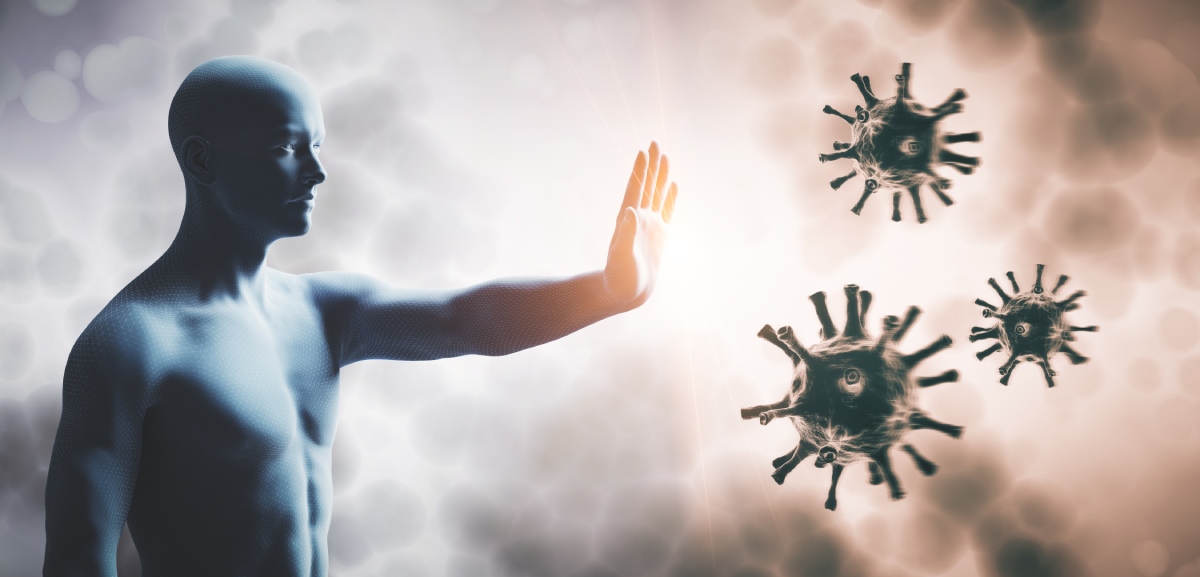 A human figure with an outstretched hand appears to be stopping representations of viruses, symbolizing immune defense.
