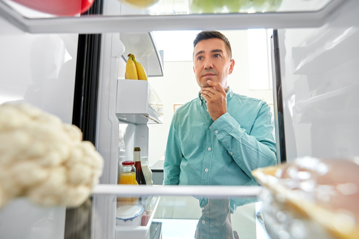 aged man man looking for food in fridge, eating and diet concept