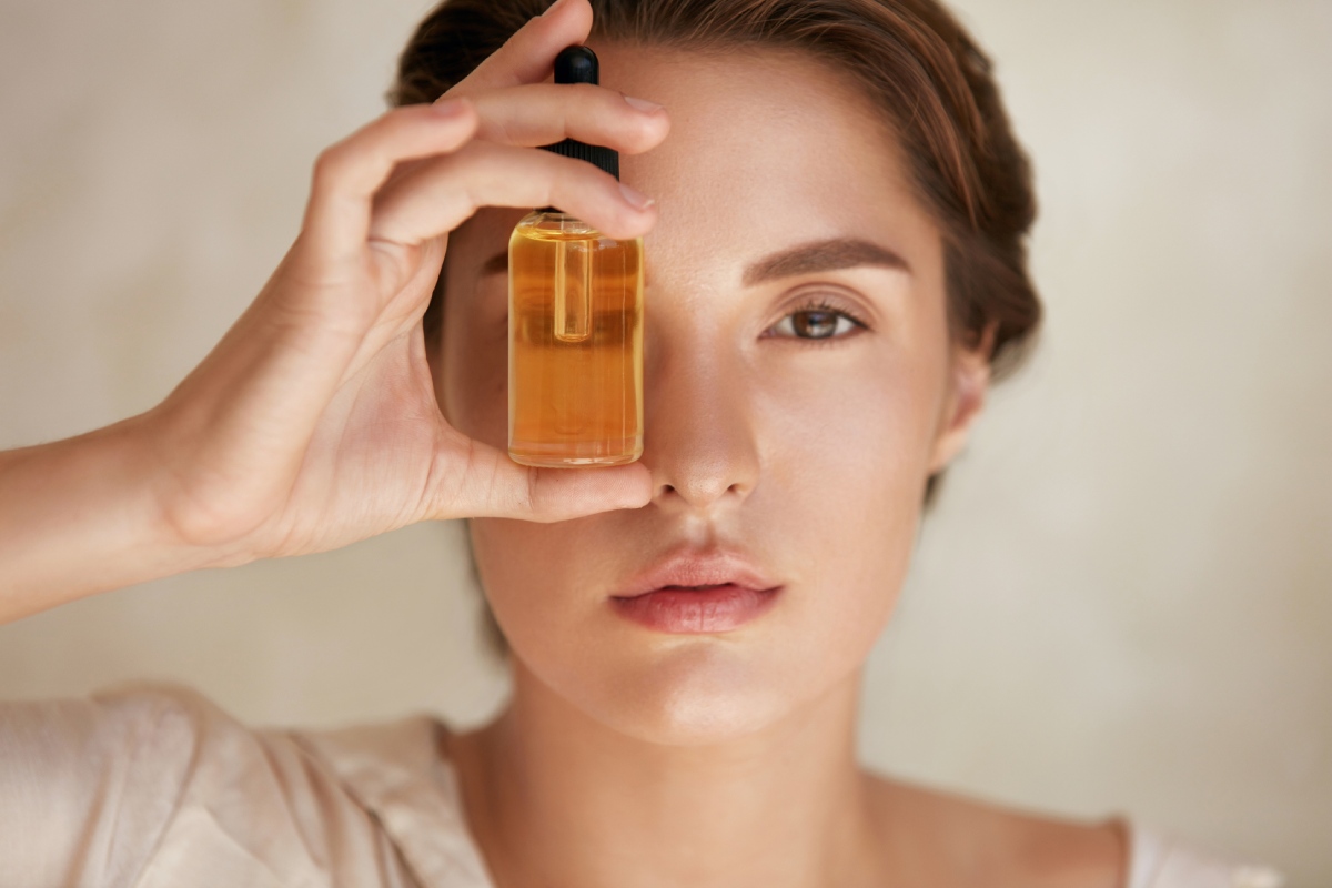 Beauty portrait of woman with bottle serum