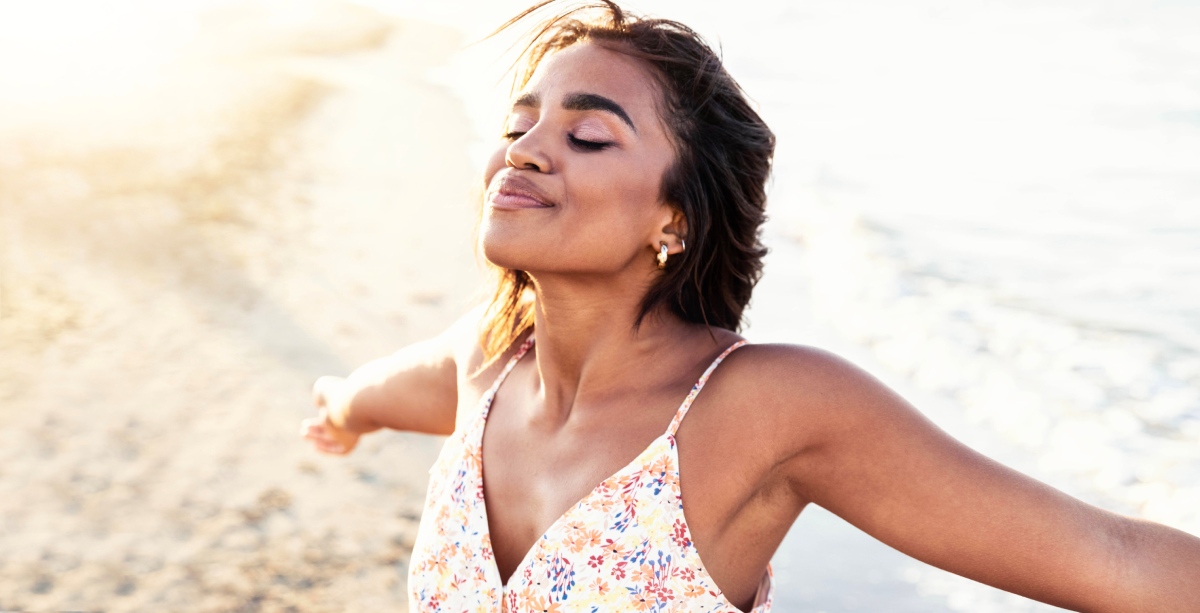 happy woman with open arms enjoying nature