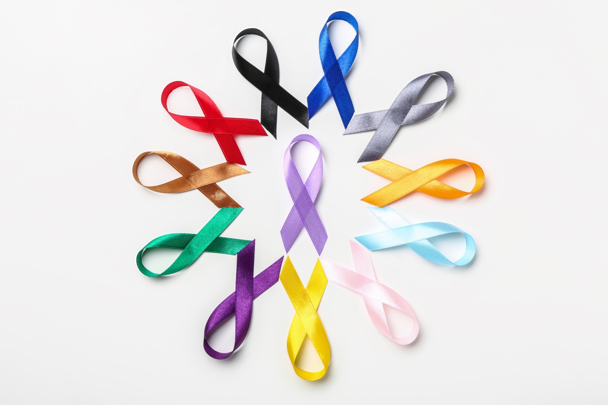 A circular arrangement of colorful awareness ribbons on a white background.