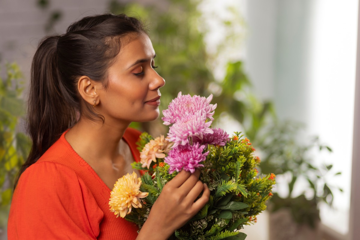 Allergy Relief | young woman with eyes closed holding flower bouquet and smelling