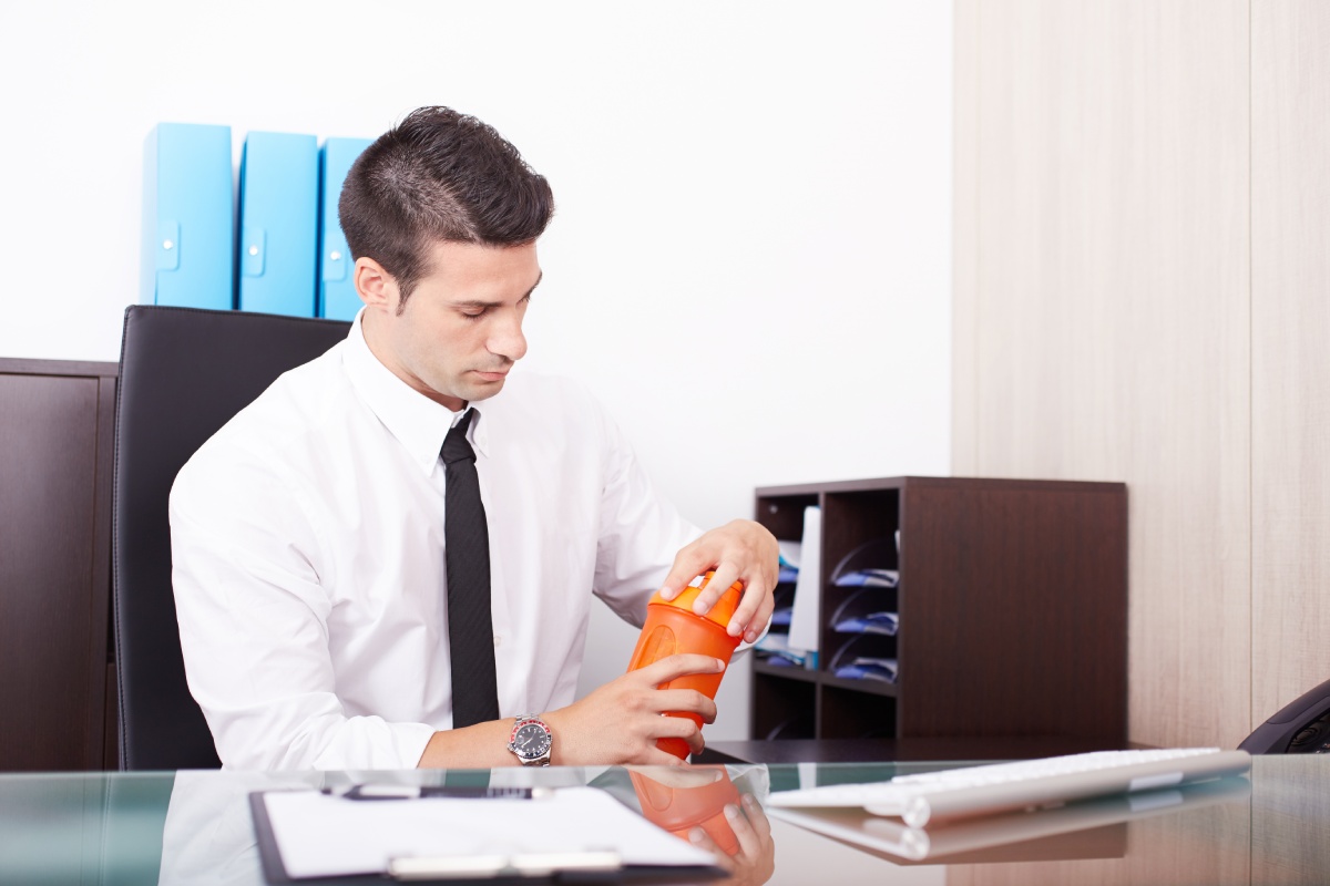 businessman shaking and drinking protein drink